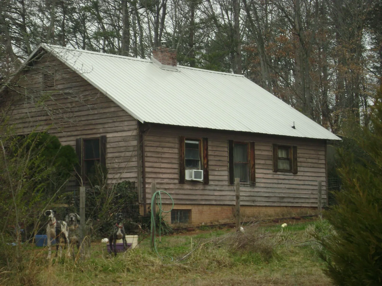 White metal roof on an old wood sided farmhouse, from a Metal Roof Installation job in Aroda